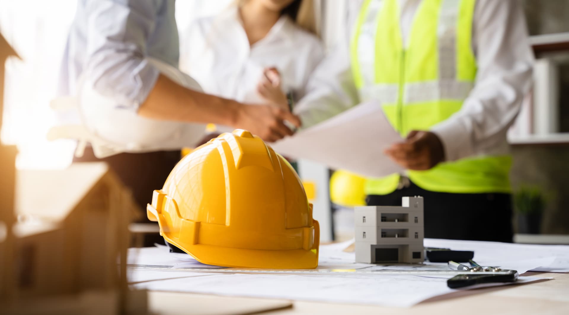 contractors reviewing construction documents in office