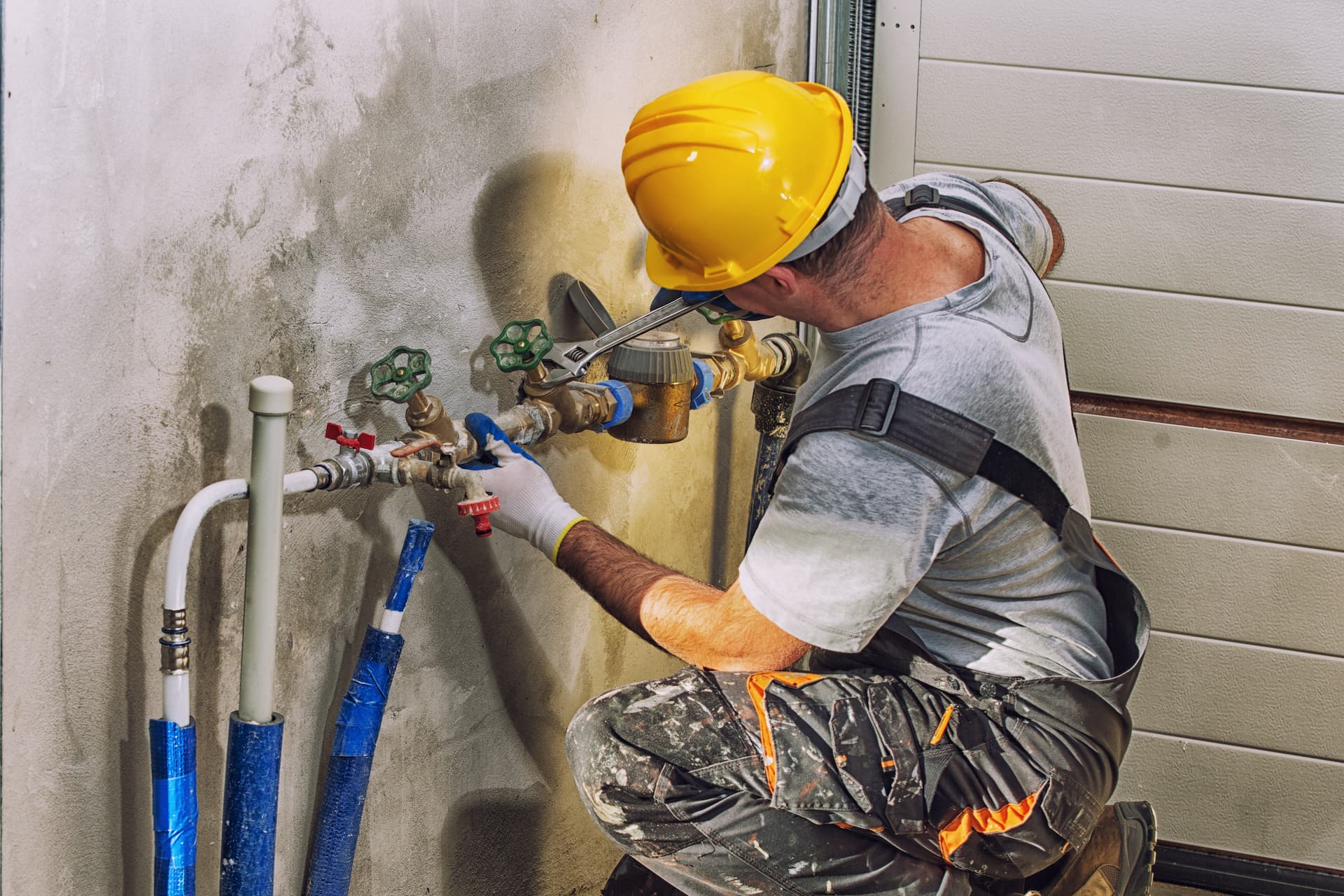 Plumbing subcontractor adjusting water valve